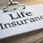 Supplemental Life insurance document on clipboard